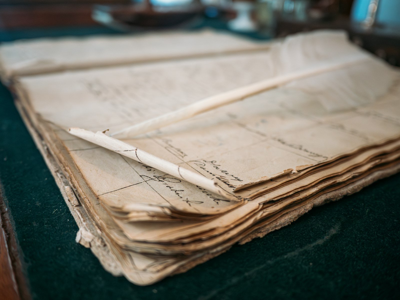 Close-up of an old open ledger with handwritten entries in faded ink